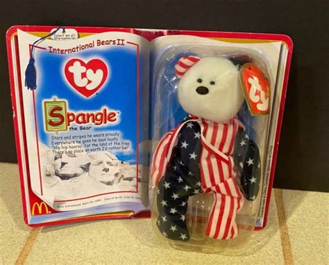 Spangle is a rare and collectible bear with a pink face and original tags. . Spangle beanie baby